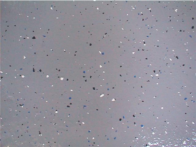 Close-up of grey epoxy with chips and non slip adhesive